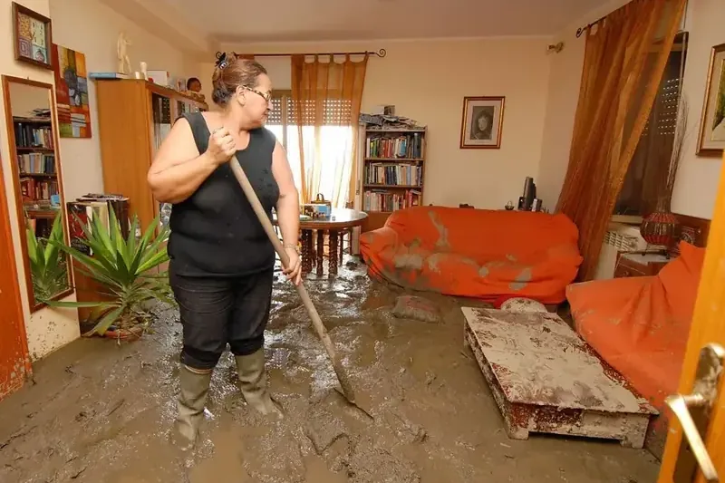 Muddy water covering a living room floor after flooding